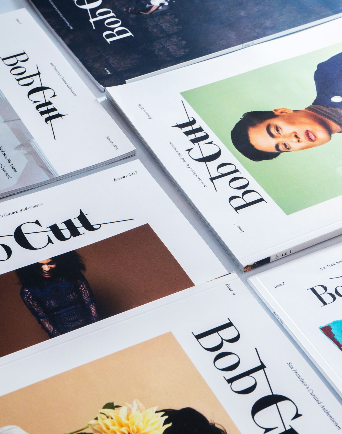 A layered stack of magazines representing publishing